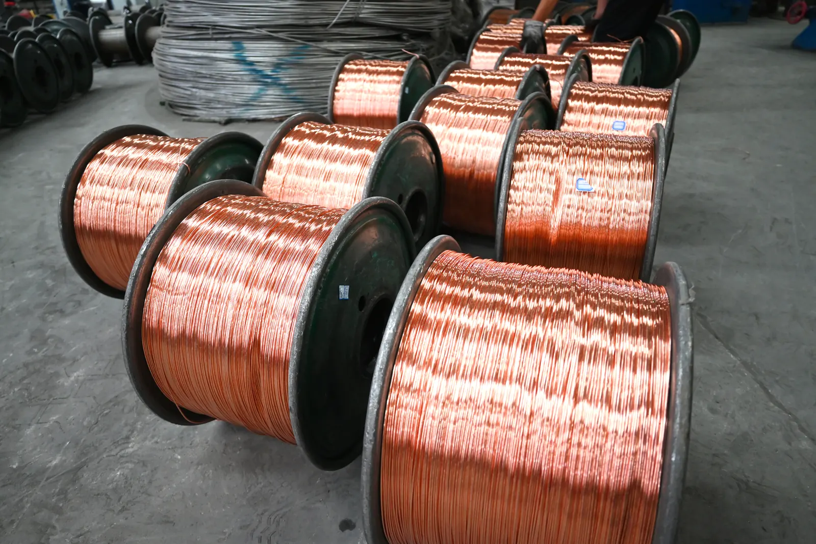 Bare drawn copper wire on bobbins staged inside the Yaxing plant